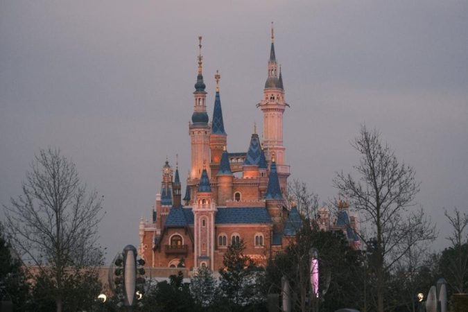 Enchanted Disney castle illuminated at dusk during peaceful shoulder season visit