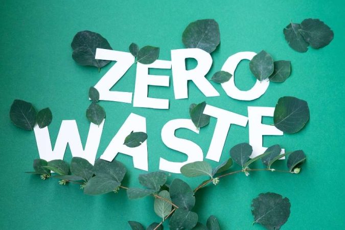 Zero waste travel message displayed with natural green leaves on eco-friendly background