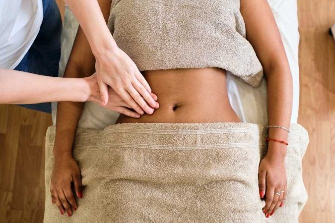 Lymphatic drainage massage on abdomen to stimulate circulation and detox